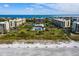 Scenic aerial view of luxurious condos near a beach, with community pool and beach access at 1145 Gulf Of Mexico Dr # 305, Longboat Key, FL 34228