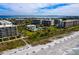 Aerial view showcasing condos with private beach access, pool, and beautiful coastal scenery at 1145 Gulf Of Mexico Dr # 305, Longboat Key, FL 34228