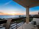 Relaxing balcony view of the ocean, beach and sunset with comfortable furniture at 1145 Gulf Of Mexico Dr # 305, Longboat Key, FL 34228