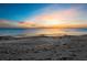 Tranquil beach featuring a colorful sunset with calm ocean waters at 1145 Gulf Of Mexico Dr # 305, Longboat Key, FL 34228