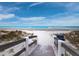 Sandy beach access through the dunes offers ocean views and beach chair seating at 1145 Gulf Of Mexico Dr # 305, Longboat Key, FL 34228