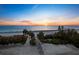 Sunrise view of the beach and ocean from the community beach access point at 1145 Gulf Of Mexico Dr # 305, Longboat Key, FL 34228