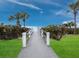 A boardwalk leads to the beach lined with greenery and views of the ocean at 1145 Gulf Of Mexico Dr # 305, Longboat Key, FL 34228