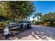 Outdoor grilling area with several grills and lush landscaping, perfect for hosting barbecues and enjoying the beautiful weather at 1145 Gulf Of Mexico Dr # 305, Longboat Key, FL 34228