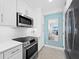 Close-up of stainless steel appliances and white cabinetry in a modern kitchen design at 1145 Gulf Of Mexico Dr # 305, Longboat Key, FL 34228