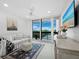 Bright living room featuring a large window with a view, comfortable seating and modern décor at 1145 Gulf Of Mexico Dr # 305, Longboat Key, FL 34228