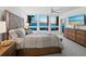 Cozy main bedroom with large windows showcasing ocean views and stylish furniture at 1145 Gulf Of Mexico Dr # 305, Longboat Key, FL 34228