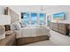 Comfortable main bedroom with ocean views, a ceiling fan, and elegant decor at 1145 Gulf Of Mexico Dr # 305, Longboat Key, FL 34228