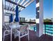 Outdoor seating area overlooking a swimming pool, providing a relaxing space to enjoy the sun and poolside activities at 1145 Gulf Of Mexico Dr # 305, Longboat Key, FL 34228