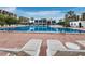 Beautiful view of a pool with lounge chairs, tables, and umbrellas for community enjoyment at 1145 Gulf Of Mexico Dr # 305, Longboat Key, FL 34228