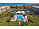 Aerial view of the community pool, clubhouse, ponds, and surrounding landscaping at 1145 Gulf Of Mexico Dr # 305, Longboat Key, FL 34228