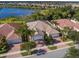 An aerial view of the house and surrounding community with lake and palm trees at 11629 Garessio Ln, Sarasota, FL 34238