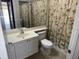 Cozy bathroom with floral shower curtain, sink with vanity and toilet at 11629 Garessio Ln, Sarasota, FL 34238