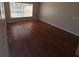 View of bedroom with wood floors and window offering natural light at 11629 Garessio Ln, Sarasota, FL 34238