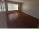 View of bedroom with wood floors and window offering natural light at 11629 Garessio Ln, Sarasota, FL 34238