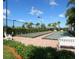 Two community bocce ball courts are surrounded by lush greenery, benches, and palm trees at 11629 Garessio Ln, Sarasota, FL 34238