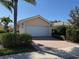 Well-maintained home features a two-car garage, paver driveway, and tidy landscaping at 11629 Garessio Ln, Sarasota, FL 34238