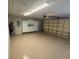 Spacious two car garage with built-in storage cabinets and epoxy flooring at 11629 Garessio Ln, Sarasota, FL 34238