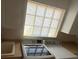 A bright laundry room featuring a sink, washer, dryer, and a skylight window at 11629 Garessio Ln, Sarasota, FL 34238