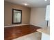 Open concept living room with wood flooring and neutral paint at 11629 Garessio Ln, Sarasota, FL 34238