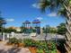 Community playground area with modern equipment, lush greenery, and a secure fence at 11629 Garessio Ln, Sarasota, FL 34238