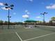 Several community tennis courts with lighting, benches, and covered seating at 11629 Garessio Ln, Sarasota, FL 34238