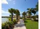 Scenic community walking path beside the lake. Featuring lush landscaping and benches at 11629 Garessio Ln, Sarasota, FL 34238