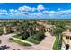 Aerial view of clubhouse surrounded by palm trees, tennis courts and lakes at 12510 Ghiberti Cir # 102, Venice, FL 34293