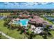 Aerial shot showcasing a community clubhouse, a large pool, and many lounge chairs at 12510 Ghiberti Cir # 102, Venice, FL 34293