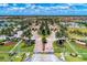 Aerial shot of residential area featuring manicured landscaping, gated entrance, and palm trees at 12510 Ghiberti Cir # 102, Venice, FL 34293