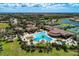 Community aerial view showcasing large pool, spa, clubhouse, tennis courts, lakes and surrounding landscape at 12510 Ghiberti Cir # 102, Venice, FL 34293