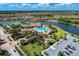 Aerial view of the community clubhouse, pool, tennis courts, and surrounding lakes and neighborhood at 12510 Ghiberti Cir # 102, Venice, FL 34293