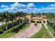 Aerial view of a gated community entrance showcasing lush landscaping and stunning architecture at 12510 Ghiberti Cir # 102, Venice, FL 34293