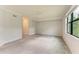 Large room with neutral tones and a wide window with natural light at 12510 Ghiberti Cir # 102, Venice, FL 34293