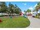 Lawn area with colorful seating and boardwalk near eateries offers a vibrant community space at 12510 Ghiberti Cir # 102, Venice, FL 34293