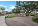 Lawn area with colorful seating and wooden boardwalk provide a relaxing community space at 12510 Ghiberti Cir # 102, Venice, FL 34293