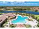 Aerial shot of a large community pool, surrounded by lounge chairs and palm trees, perfect for relaxation at 12510 Ghiberti Cir # 102, Venice, FL 34293