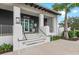 Modern building entrance with white pillars, black accents, and neat landscaping at 12510 Ghiberti Cir # 102, Venice, FL 34293