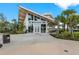 Stunning building exterior with unique architectural design, lush landscaping, and ample windows offering natural light at 12510 Ghiberti Cir # 102, Venice, FL 34293