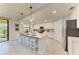 Well-lit kitchen boasts an island with seating, pendant lights, and sliding glass doors leading to an outdoor area at 12510 Ghiberti Cir # 102, Venice, FL 34293