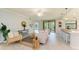 Inviting living room featuring stylish furniture, a striped rug, and sliding glass doors to a screened-in porch at 12510 Ghiberti Cir # 102, Venice, FL 34293