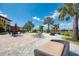 Lounge chairs and seating with palm trees under a bright sky with lake view at 12510 Ghiberti Cir # 102, Venice, FL 34293