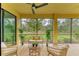 A screened porch with wicker furniture and a view at 12510 Ghiberti Cir # 102, Venice, FL 34293