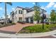 Upscale building featuring outdoor seating, brick sidewalk and manicured landscaping under blue skies at 12510 Ghiberti Cir # 102, Venice, FL 34293