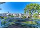 A balcony view overlooking the community pool, American flag, and complex buildings at 1517 Pleasant Rd # A22, Bradenton, FL 34207