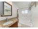 Bathroom featuring a granite vanity, a large mirror and a shower over tub combo at 1517 Pleasant Rd # A22, Bradenton, FL 34207