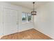 Dining area with hardwood floors, bright window, and decorative light fixture at 1517 Pleasant Rd # A22, Bradenton, FL 34207