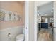 Powder room with stylish decor adjacent to kitchen at 1555 Napoli W Dr, Sarasota, FL 34232