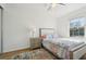 Cozy bedroom with wood floor, soft neutral colors and a bright window creates a calming atmosphere at 1555 Napoli W Dr, Sarasota, FL 34232