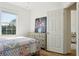 Charming bedroom with wood floor, soft neutral colors and a bright window provides ample natural light at 1555 Napoli W Dr, Sarasota, FL 34232